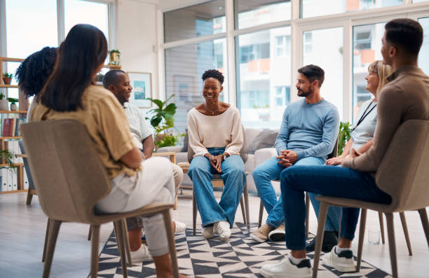 istock A diverse group of people attending a support group session, engaging in open conversation in a comfortable and modern setting. The participants appear relaxed and supportive of each other. 2159641939