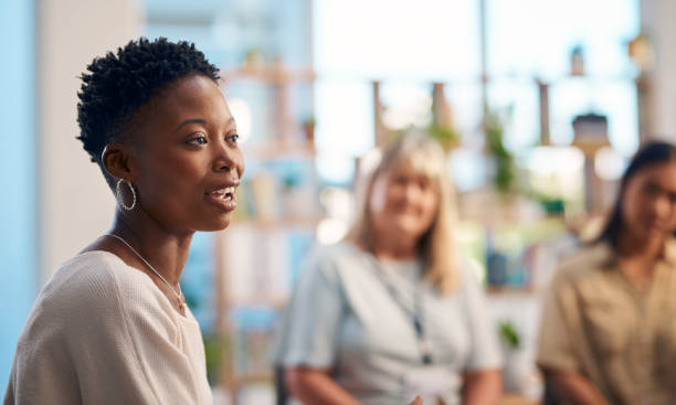 istock A diverse group of individuals attending a support group session, with a focus on one individual sharing her thoughts. The environment is open and supportive, encouraging connection and emotional support. 2159641987