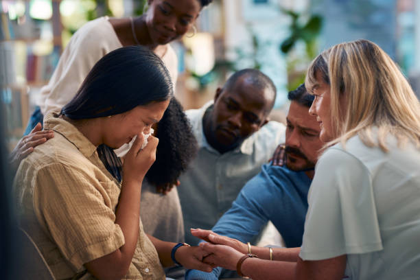istock A diverse group of people gathered in a support group offering emotional support and comfort to a crying individual. The scene conveys care, compassion, and community in a safe space for sharing feelings. 2159642004
