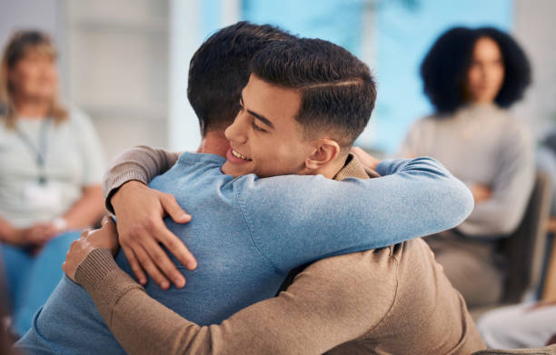 istock Warm Embrace Among Diverse Group In A Support Meeting 2159642014