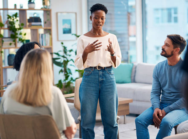 istock This image captures a diverse group of people participating in a support group session. They are seated comfortably in a cozy, well-lit room, engaging in conversation and offering emotional support to each other. 2159642023