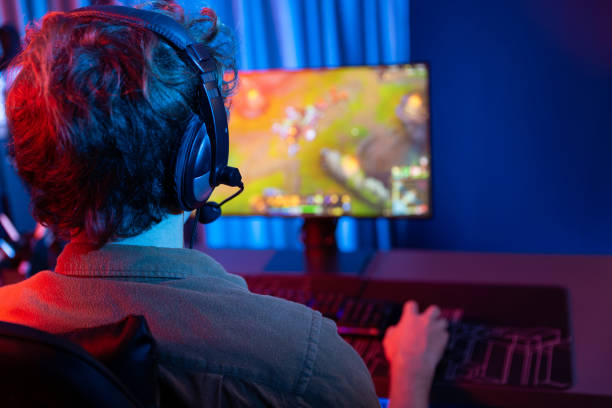 istock Streamer playing fighting Moba, wearing headphone and mic at back side. Gusher. 2159643416