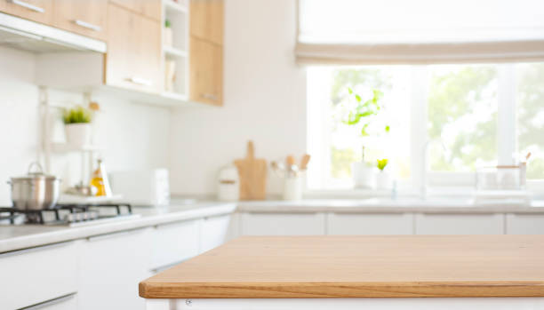 istock Space for product montage on wooden table top over blurred kitchen counter interior background 2159644469