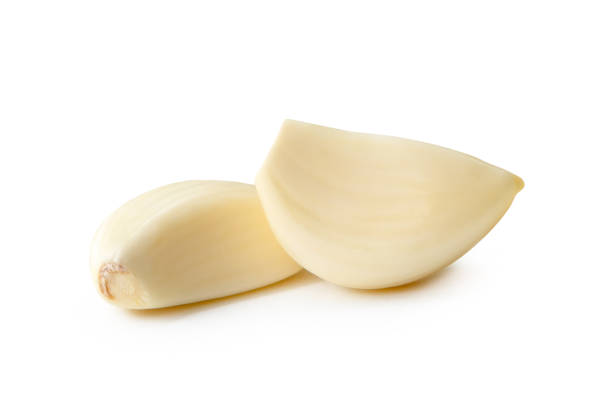 istock Front view of white peeled garlic cloves isolated on white background with clipping path 2159650085