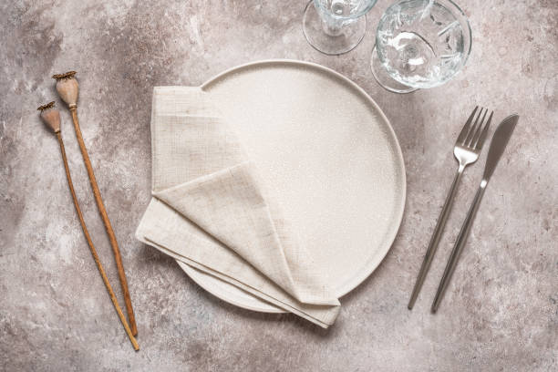 istock Autumn table setting, beige plate, cutlery, glasses and dried poppy boxes on a rustic background. Top view, flat lay, selective focus. 2159651731