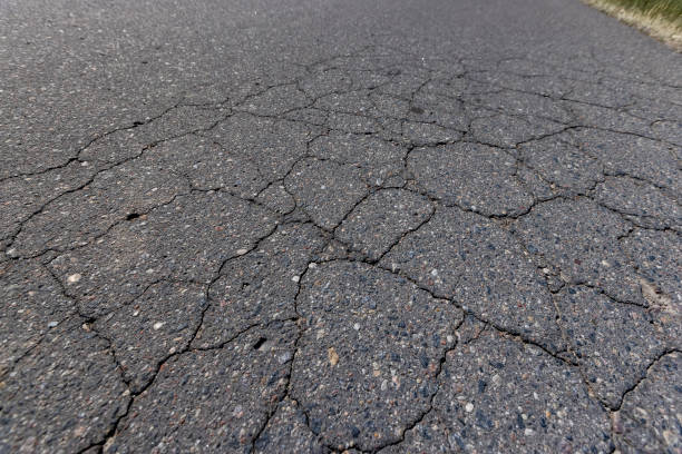 details asphalting of a road , a part of a highway covered with cracked asphalt