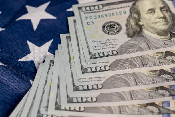 istock American dollars and the American flag 2159651953