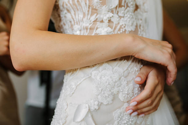 istock Wedding preparation, wedding gown being tied up 2159654756