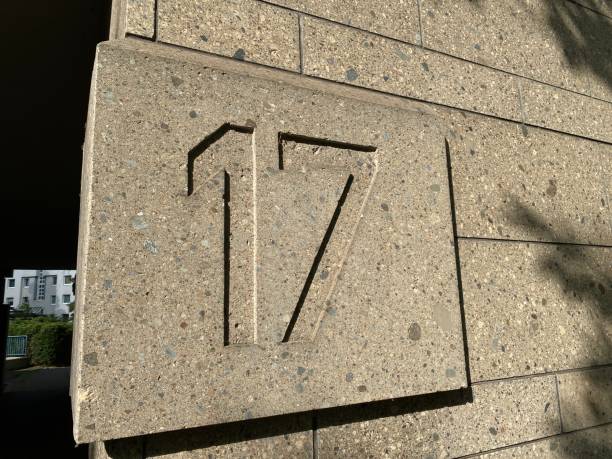 istock House number 17 carved in stone 2159654765