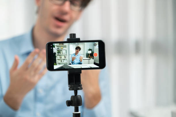 istock Influencer using phone streaming online focusing phone with portrait. Gusher. 2159655207