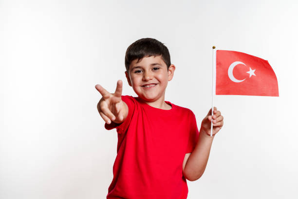 istock A young boy is holding a turkish flag with a peace sign 2159655256
