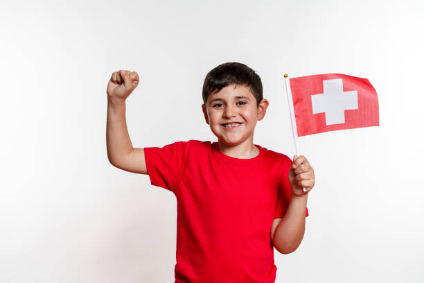 istock A young boy is holding a switzerland flag and succes concept 2159655320
