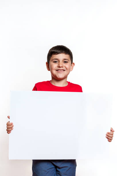 istock A young boy is holding a white sign 2159655407
