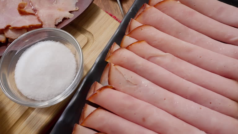 Close-up panning view of ingredients for smoked ham bread baking or "Pan de Jamon" in a rustic kitchen