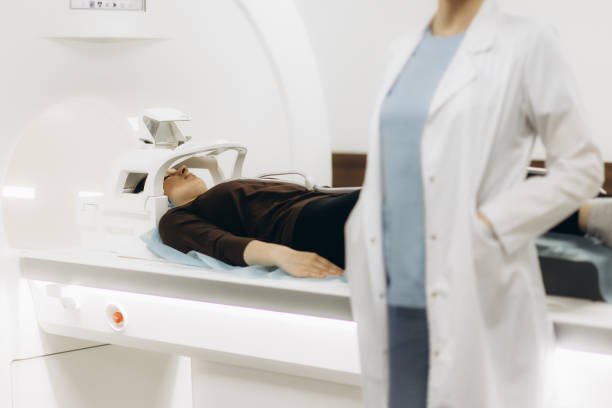 istock Doctor Looking At Female Patient Going Through CT Scan 2159655897
