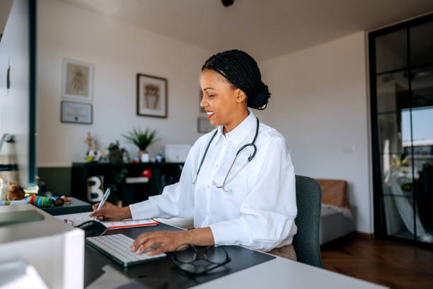 istock Female doctor using desktop PC at the modern office 2159656071