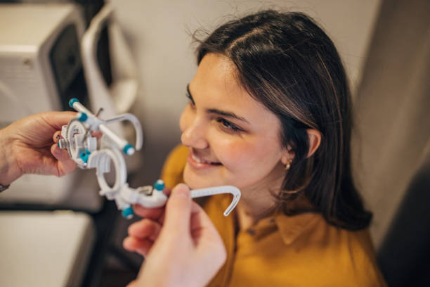 istock Smiling woman wearing trial frame, close-up in clinic 2159656848