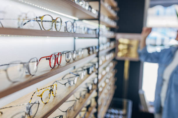 View of eyeglass display shelves in optical retailer. A well-organized view of eyeglass display shelves, showcasing a variety of eyeglass frames in different styles and colors, perfectly captured in a modern optical store with a bright ambiance. optometry stock pictures, royalty-free photos & images