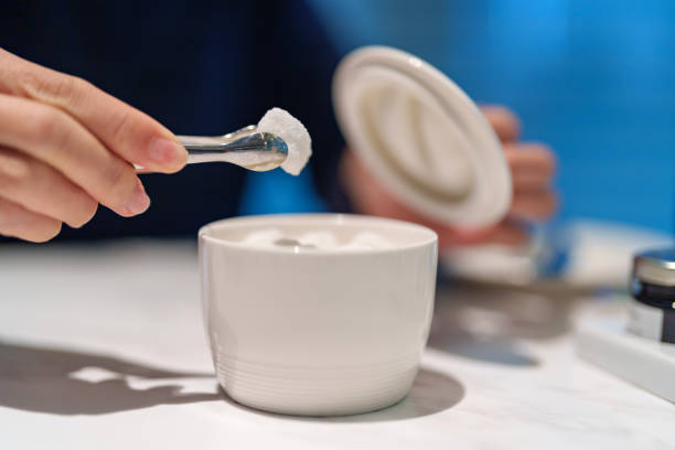 A cropped image of a woman picking up a sugar cube from a white jar in a restaurant, highlighting the concept of poor nutrition and lifestyle.
