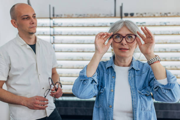 istock Woman holding glasses in spacious optical store. 2159657810