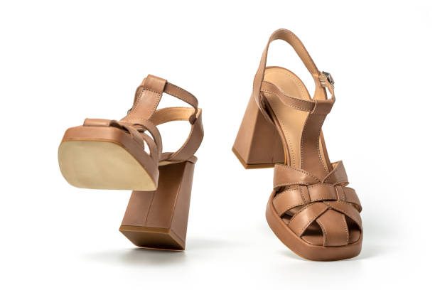 istock Pair of brown suede female sandals on white 2159657936