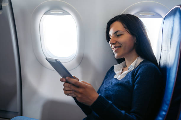 istock Young Woman Using Digital Tablet In An Airplane 2159657974