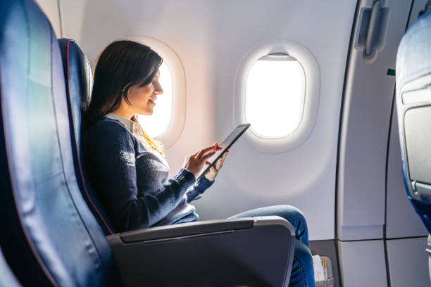istock Young Woman Using Digital Tablet In An Airplane 2159658030