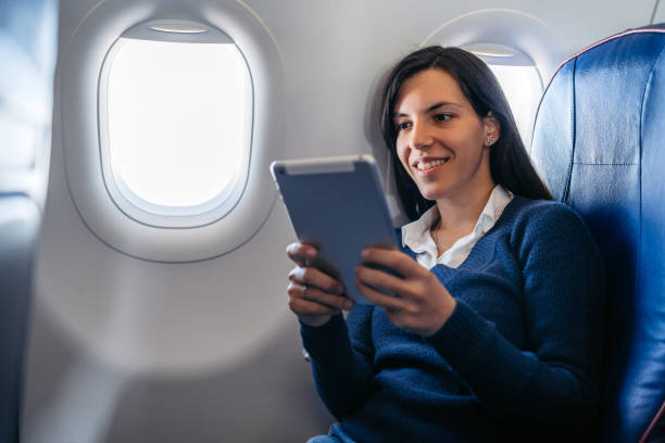 istock Young Woman Using Digital Tablet In An Airplane 2159658037