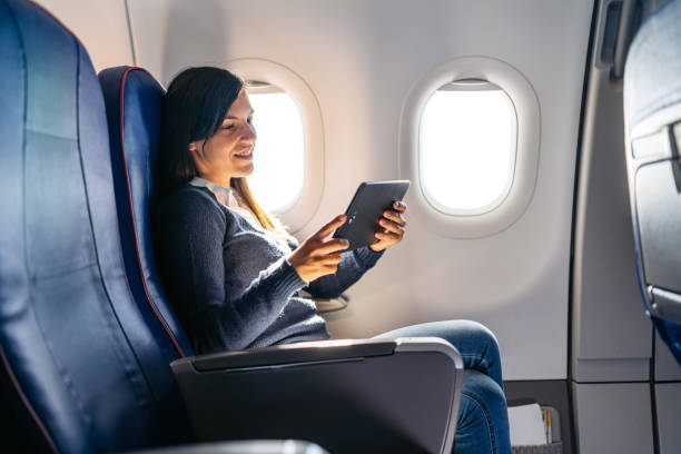 istock Young Woman Watching Something On The Digital Tablet In An Airplane 2159658626