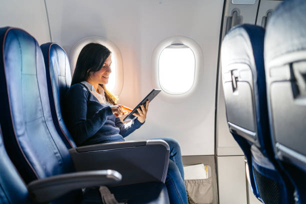 istock Young Woman Using Digital Tablet In An Airplane 2159658636