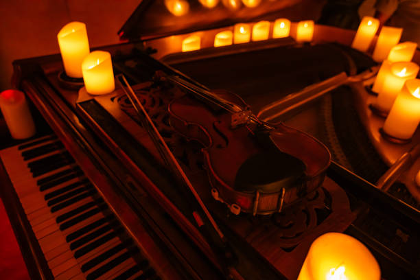 istock Violin on pianoforte with candles 2159658822