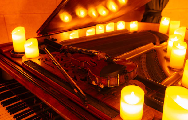 istock Violin on pianoforte with candles 2159658947