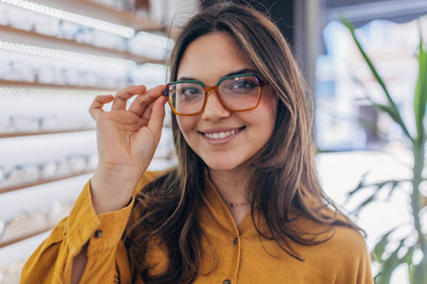 istock Woman smiling while wearing glasses in eyewear store 2159659032