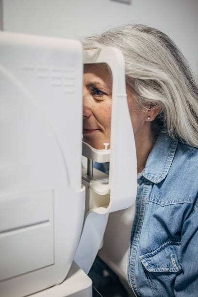 istock Woman undergoing eye examination with medical device. 2159659640