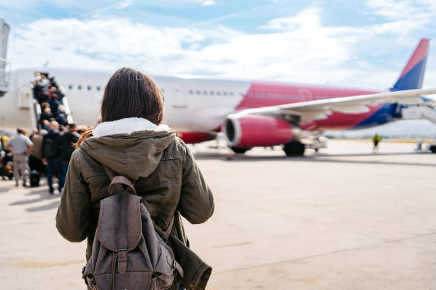 istock Young Woman Boarding An Airplane 2159659651