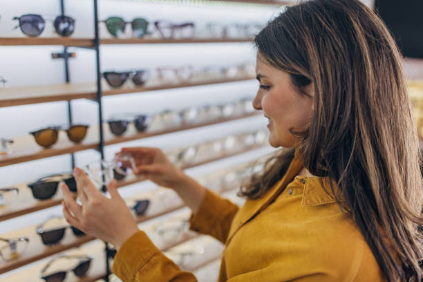 istock Customer examining glasses at an optical store display. 2159661800