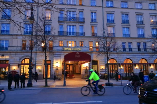 Berlin in Germany - March 13 2024: The Adlon Hotel, people walking on the street near the hotel