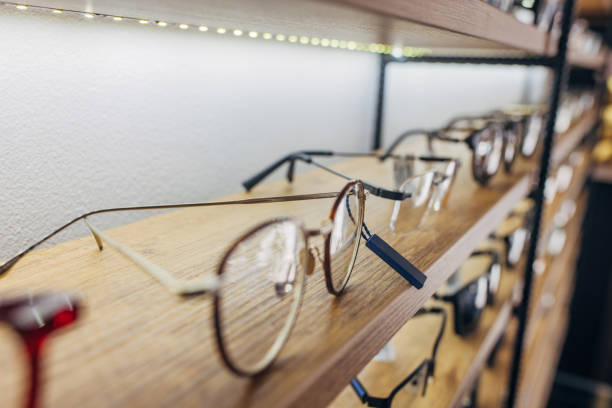 istock Elegant eyeglasses on a wooden shelf under soft lighting 2159662387