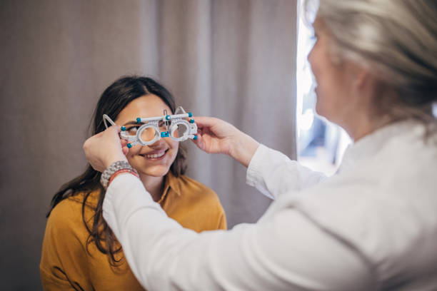 istock Eye exam in progress with patient wearing trial frames 2159662523
