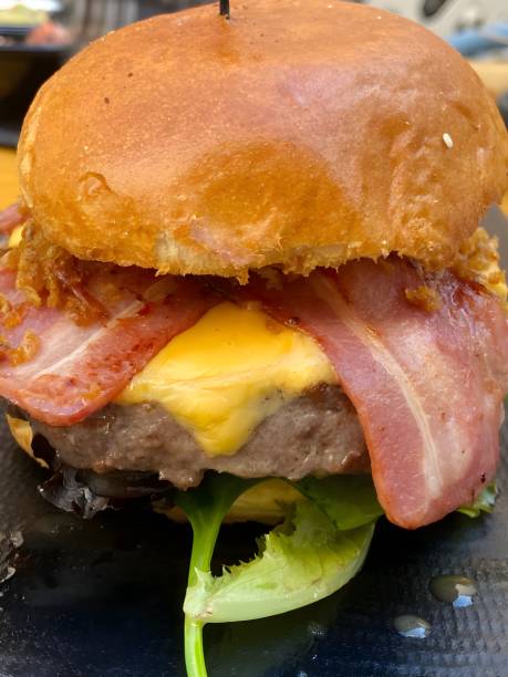 istock A large delicious burger with bacon, cheese, and lettuce. 2159662529