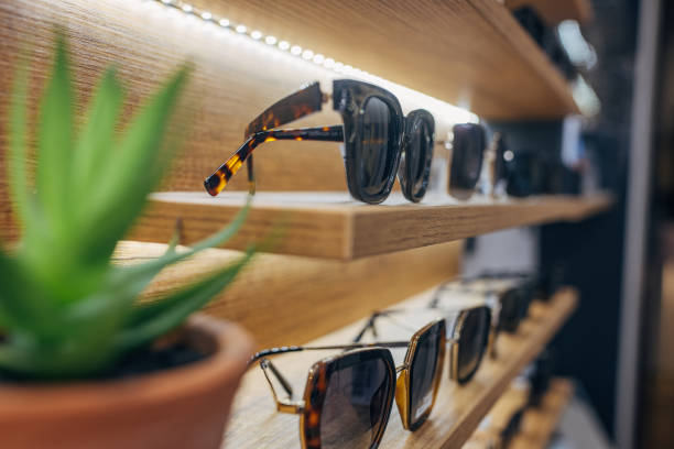 Modern display of sunglasses on wooden shelf with light