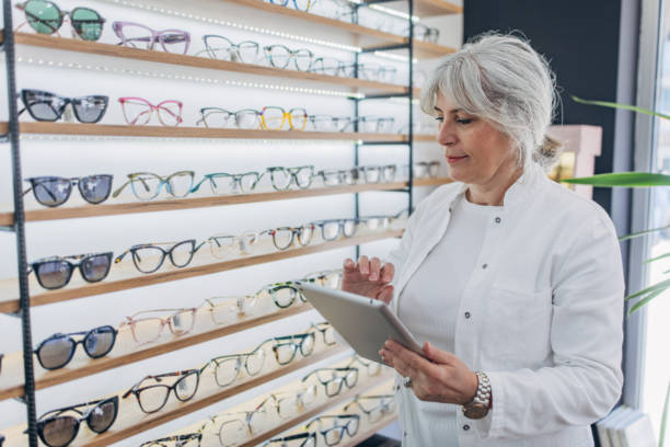 istock Optician reviewing inventory list on tablet screen 2159664792