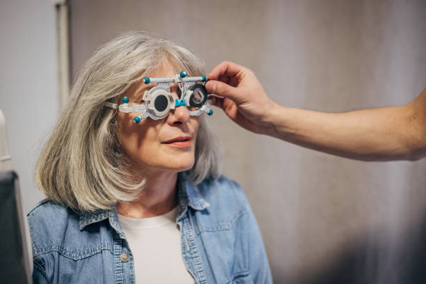 istock Optometrist prepares for vision test with elderly woman. 2159666855