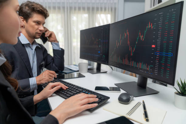 istock Man broker calling trader to high profit while woman pointing to pc. Postulate. 2159667571