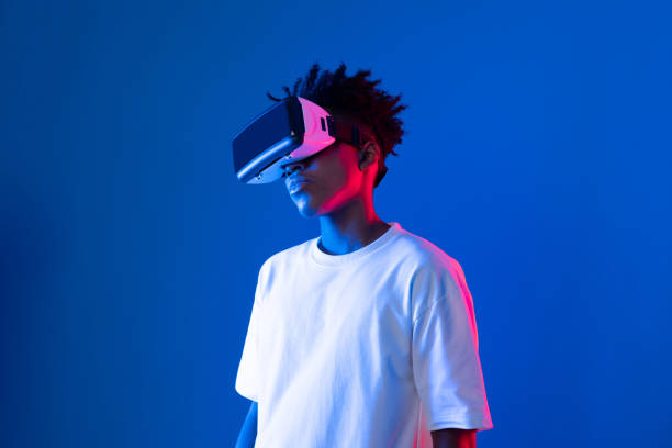 istock Surprised African looking VR holding object hologram neon wall. Contrivance. 2159668529
