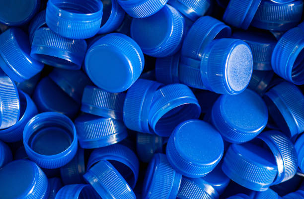 istock Top view blue plastic bottle caps.Recycling collection and production processing plastic bottle caps background ,Industrial production of bottle caps made of blue high-density polyethylene. 2159668651