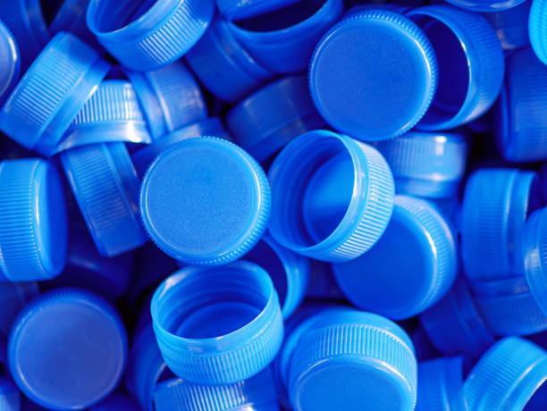 istock Top view blue plastic bottle caps.Recycling collection and production processing plastic bottle caps background ,Industrial production of bottle caps made of blue high-density polyethylene. 2159668692
