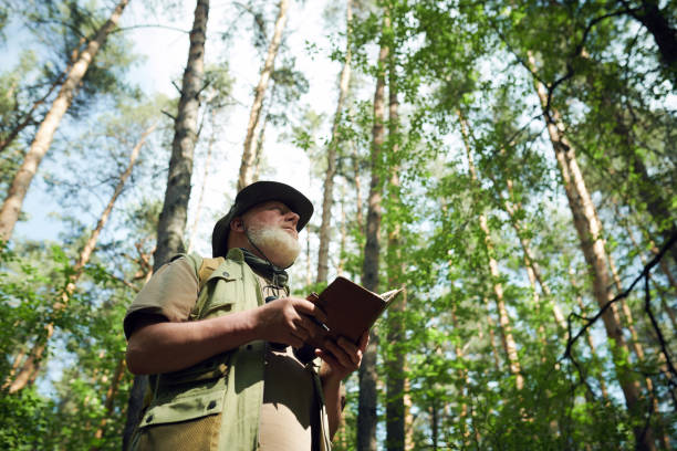 istock Senior Naturalist with Notebook Walking along Forest 2159670567