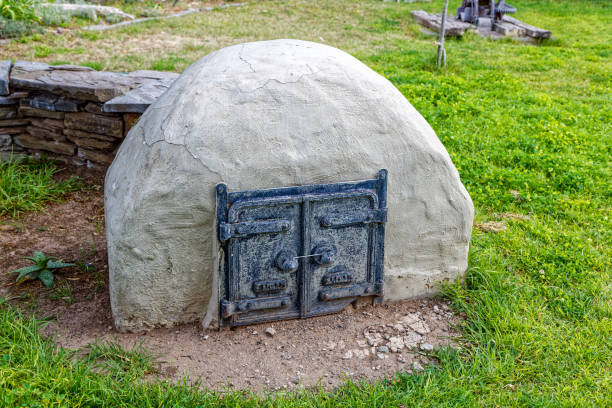 Replica of an outdoor earthen Dutch oven made from stone and clay with cast iron doors in the Karoo National Park, Western Cape, South Africa