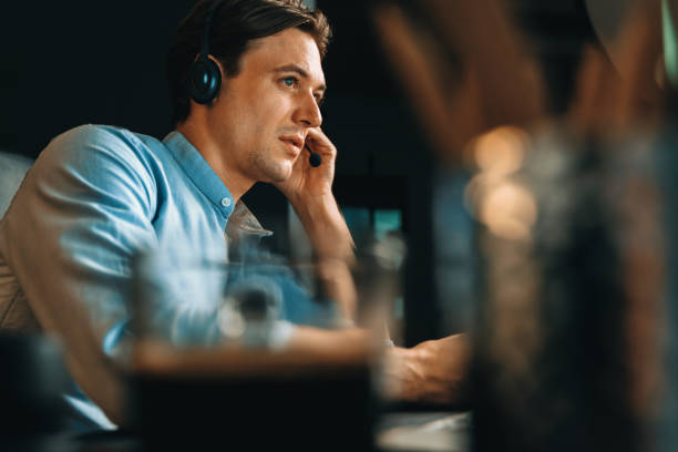 istock Call center consulting with customer on headphones on business graph. Pecuniary. 2159671295